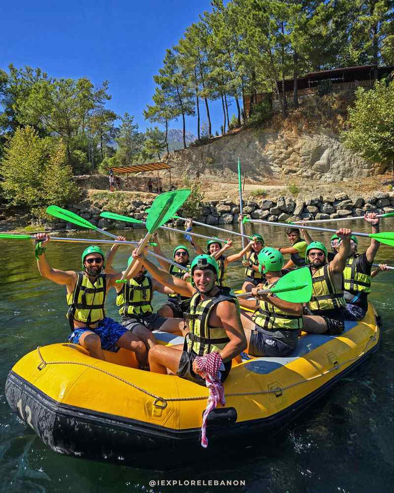 White water rafting group on a river in Lebanon wearing helmets and life jackets for a river sports adventure