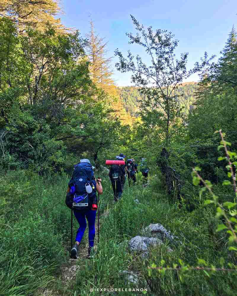 Group of trekkers walking on a long-distance trail through the mountains of Lebanon with iexplorelebanon