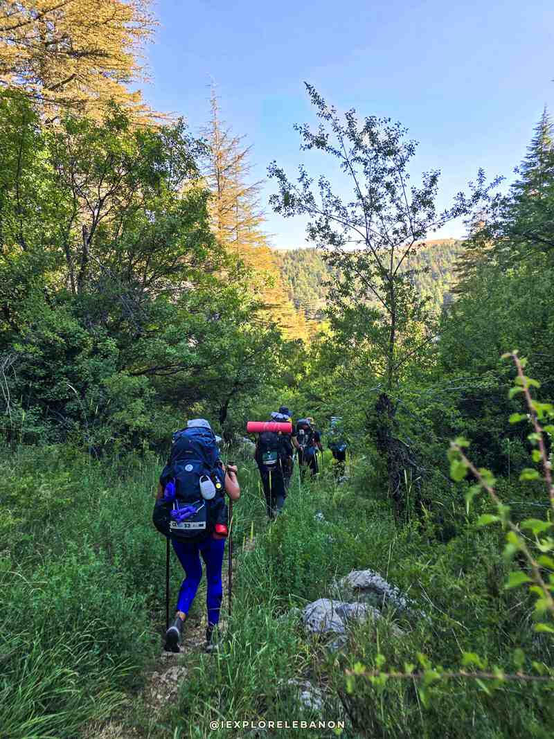 Group of trekkers walking on a long-distance trail through the mountains of Lebanon with iexplorelebanon