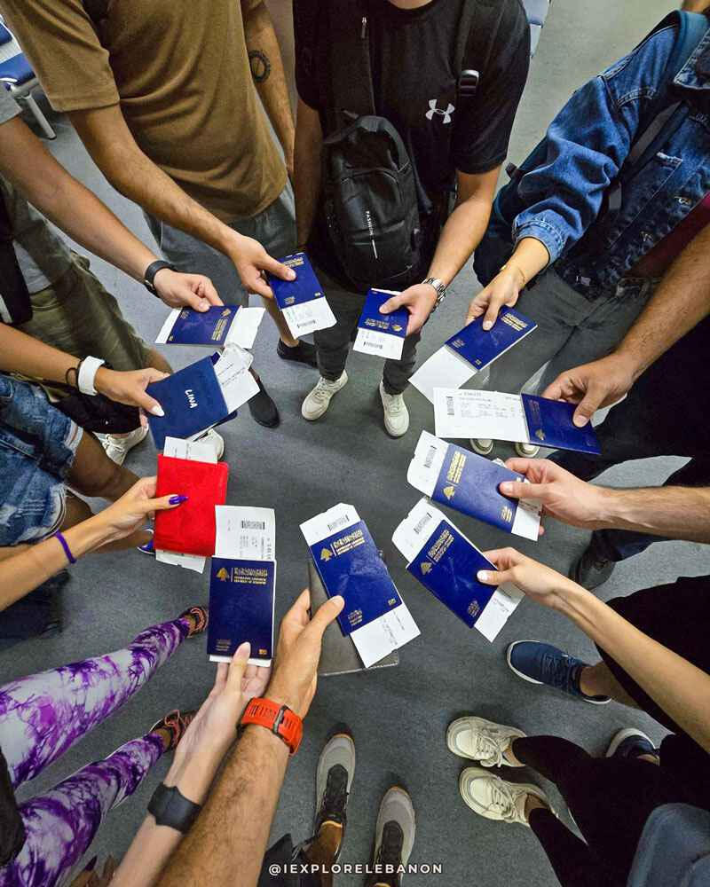 Group holding passports before an international trip from Lebanon for an adventure travel tour